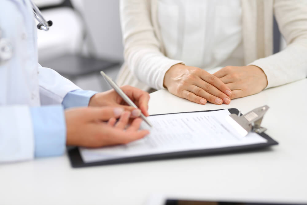 A doctor provides patient with Mymee program information