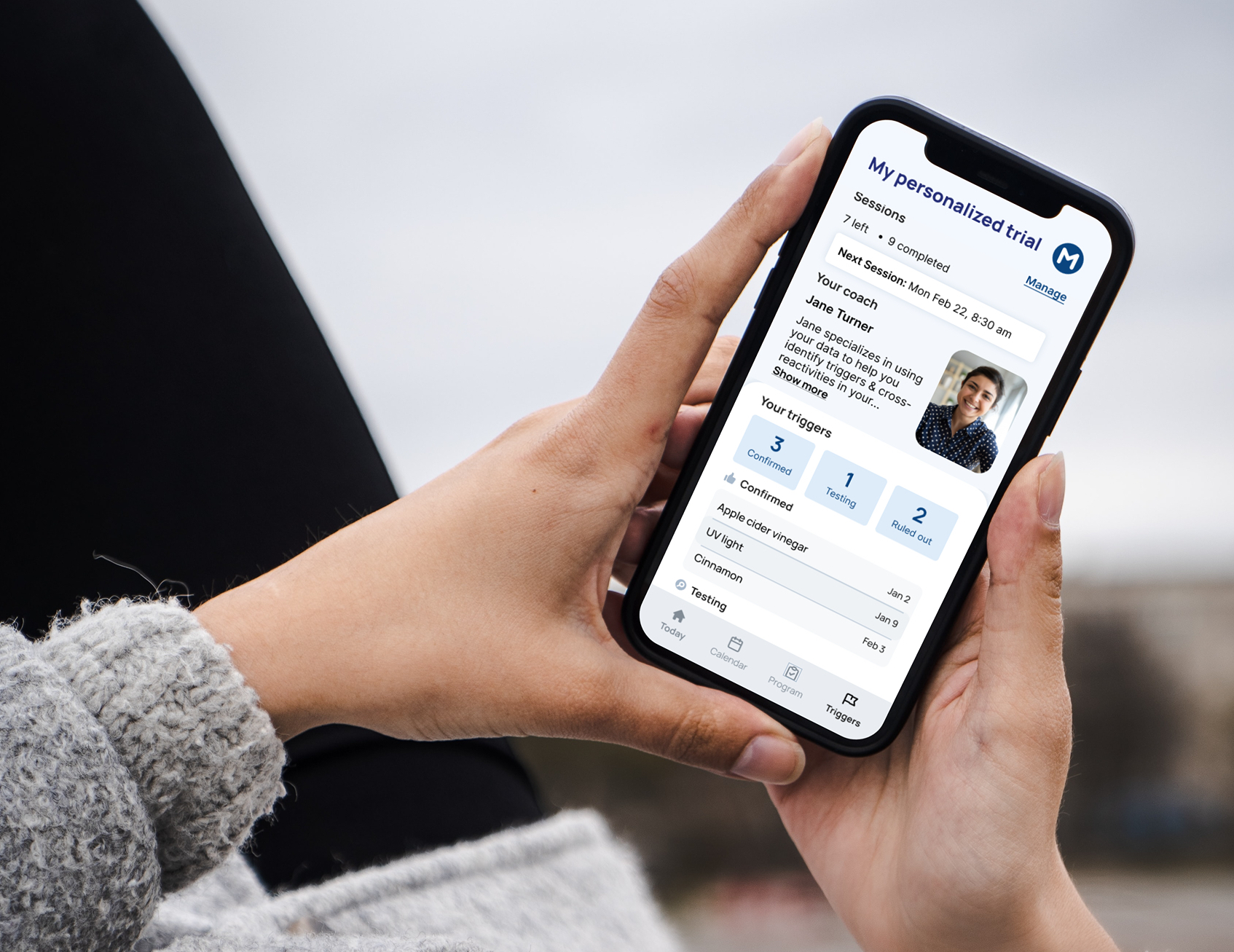 mockuuups-woman-holding-a-phone-mockup-in-both-hands (1)
